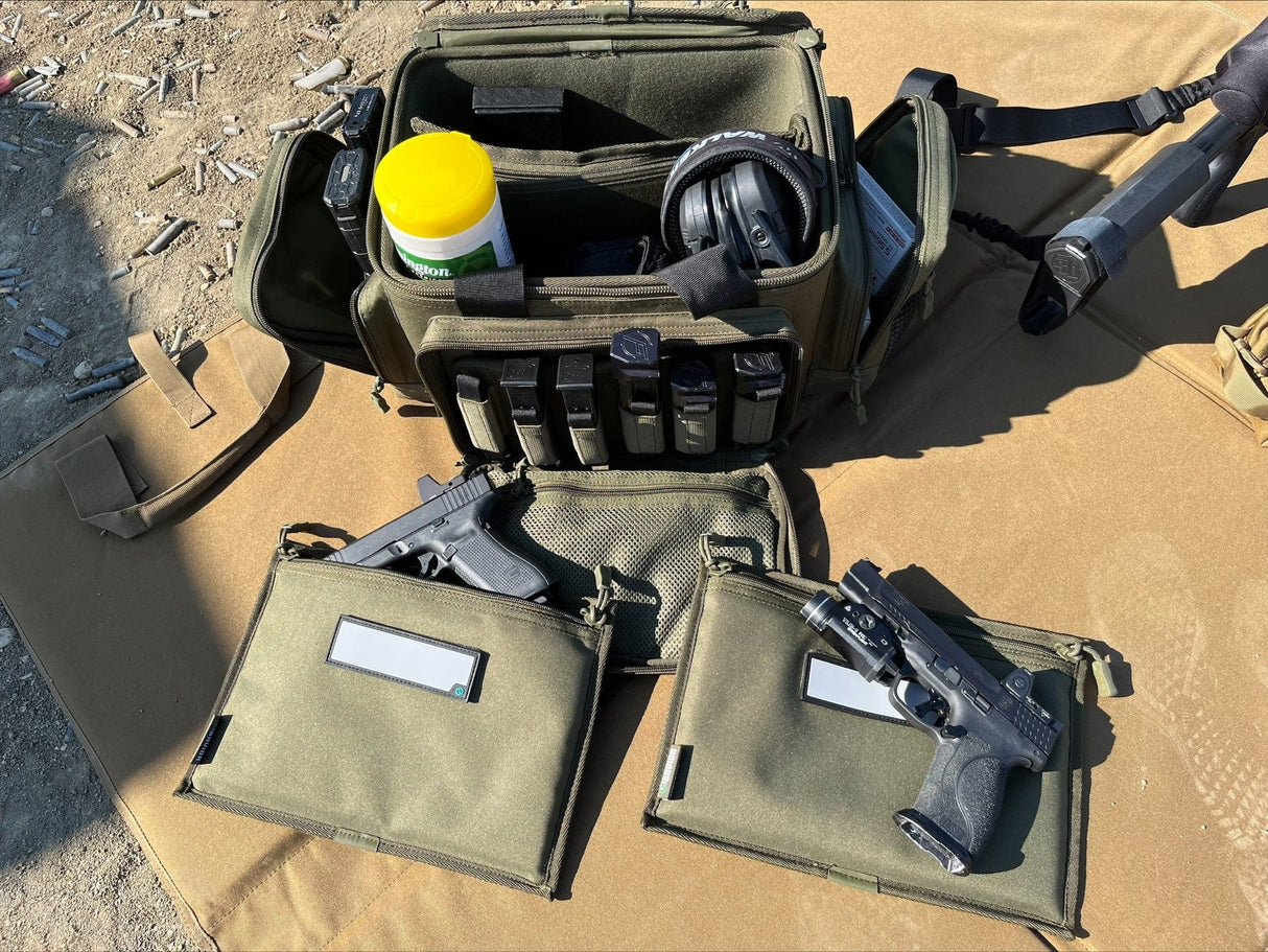 Olive green tactical pouch with gun, ammunition, and other gear on a sandy surface