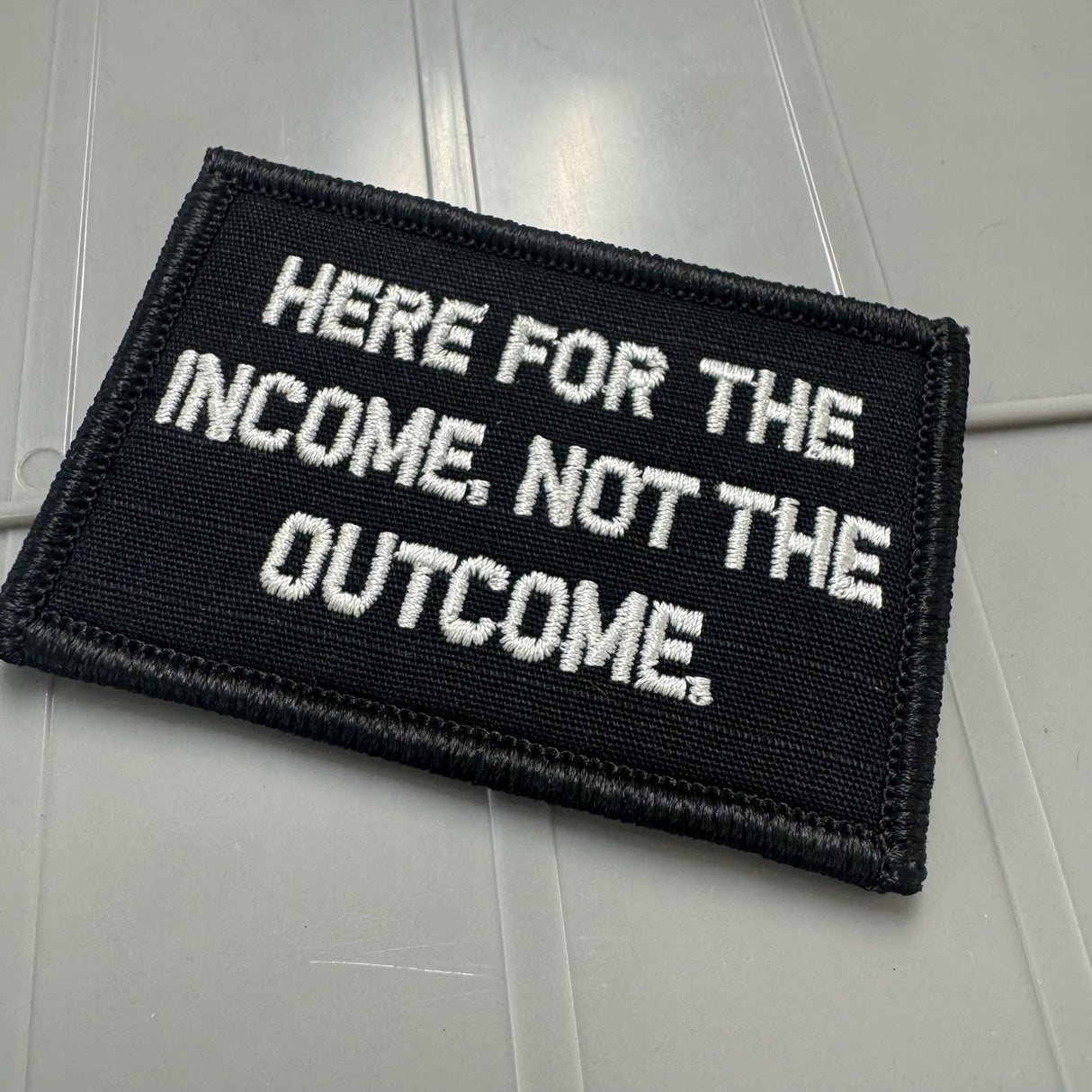 As Seen on Socials - Here For The Income, Not The Outcome. - 2x3 Patch - Black w/Silver