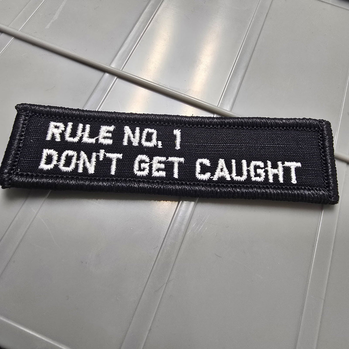 As Seen on Socials - Rule No. 1 - Don't Get Caught - 1x3.75 Patch - Black w/White
